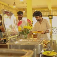 Guests enjoy filling their plates at our buffet. The open and welcoming atmosphere of our dining hall makes every meal a pleasant social experience.