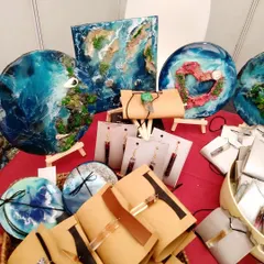 My stall at a pop-up event, showcasing my handmade resin art, including ocean-themed wall pieces, coasters, and jewelry. Many of these items are repurposed from waste.