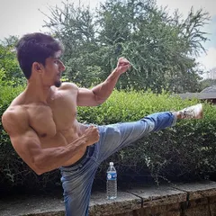 A demonstration of a high side-kick, showcasing both flexibility and the muscular definition that comes from our training.