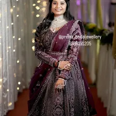 For a modern reception look, this bride is wearing a stunning diamond-look choker set with a matching maang tikka. It pairs beautifully with her elegant purple lehenga, showing how versatile my collection is for all your wedding events.