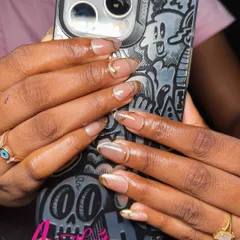 A modern and chic look featuring neutral gel extensions with a fine gold chrome line tracing the nail tip. This design is perfect for someone who loves minimalist glamour.