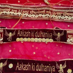 A personalized bridal accessory set, including a hanging velvet sign and a matching belt that says "Aakash ki dulhaniya".