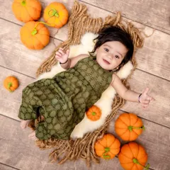 The cutest little pumpkin in our patch. We love creating seasonal sets like this autumn-themed pumpkin patch shoot, perfect for capturing your baby against a warm and festive backdrop.