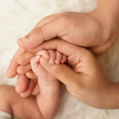 A baby's tiny foot held securely in their parents' hands. This classic shot is a beautiful way to show just how small and precious they are.