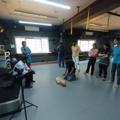 A student practices CPR on a manikin under the guidance of an instructor. This hands-on training builds life-saving skills.
