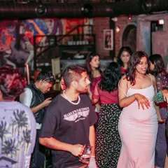 A candid shot of the crowd at an Afrodisiac event. People are mingling, dancing, and soaking in the unique atmosphere that these nights create.