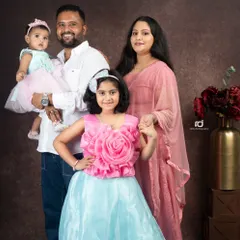 I believe family portraits should be a celebration of your unique bond. Here, a beautiful family with their two daughters, dressed in coordinating pink and blue, created a memory to cherish forever.