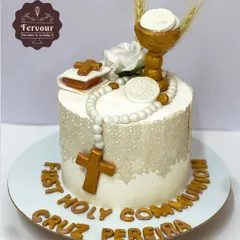 A First Holy Communion cake, designed with reverence and elegance. The cake is decorated with a fondant rosary, Bible, and chalice, with an edible lace wrap for a delicate finish.