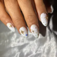 A celestial-themed design on a solid white base, with hand-painted gold stars and a protective evil eye accent.