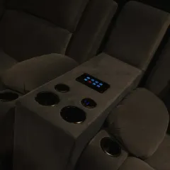 A wider shot of the automated recliners. The built-in cup holders and control panel make for a comfortable and convenient movie-watching experience.