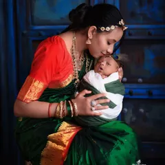 A mother's gentle kiss for her newborn. This photo, taken during our Janmashtami series, is a timeless portrait of maternal love and tenderness.