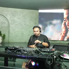 A moment of concentration during a set. I'm focused on lining up the beats and preparing for the next transition to keep the dance floor moving without interruption.