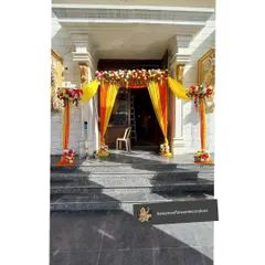 A classic and auspicious entrance decoration for a home wedding. I use bright yellow and orange drapes combined with fresh flower arrangements to create a warm and traditional welcome.
