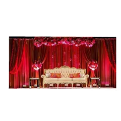 For those who love bold and dramatic themes, we design vibrant stage decor like this. The rich red draping, floral arch, and elegant seating come together to create a luxurious and royal backdrop for a wedding or reception.