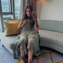 A lovely shot of the bride showing her complete mehndi. The patterns on her hands and feet are coordinated to create a unified and elegant bridal statement.