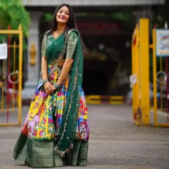 I love the blend of tradition and art in this Kalamkari-style Langa Davani. The vibrant, multi-colored skirt paired with a deep green blouse makes it a unique and eye-catching choice for festive events or cultural celebrations.