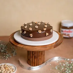 This is a chocolate and hazelnut lover's dream. Our cake is layered with moist chocolate sponge and a silky hazelnut-infused cream, then topped with a rich chocolate ganache and whole roasted hazelnuts.