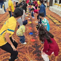 An indoor agility course using cones and ladders. We can set up our fun and challenging drills anywhere, ensuring kids get a great workout even inside a hall.