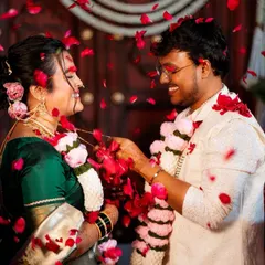 The moment of exchange. This candid shot captures the joy of a wedding ceremony, with my handmade crochet varmala right in the center of it all. The soft pink and white flowers are designed to last a lifetime.