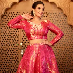 A beautiful, smiling shot that captures the joy of the festive season. The makeup enhances her features and gives her a celebratory glow.