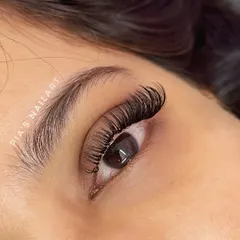 A close-up of my custom Cat Eye lash extensions. This style elongates the eye by using shorter lashes on the inner corner and gradually increasing the length towards the outer corner. It creates a beautiful, winged effect that is both glamorous and sophisticated.
