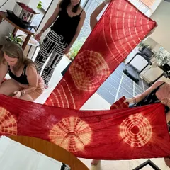 The big reveal! Participants unfurl their organic cotton stoles to see the beautiful, intricate patterns they created. The excitement in this moment is always palpable.
