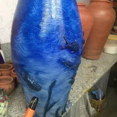 This large terracotta vase is being transformed with an underwater scene. We teach you how to properly prime and paint on porous surfaces like terracotta for a lasting finish.