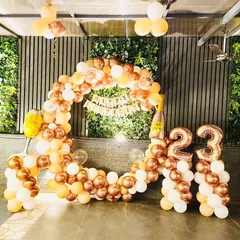 Celebrating 23 with a stunning rose gold and white balloon arch. The setup includes a 'Happy Birthday' banner and number balloons, making it a perfect, Instagrammable spot for a birthday party.