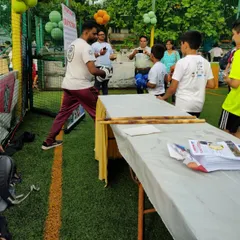 Showing a young participant how to hold the pads and throw a punch. My goal is to make martial arts accessible and fun for kids of all ages.