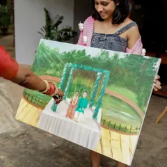 The couple admiring the finished live painting of their wedding ceremony. This is a wonderful way to capture the memory of the day in a truly unique and artistic form.