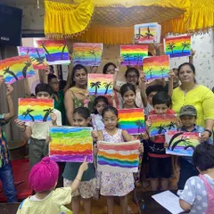 The pride on their faces says it all. Here, our young artists proudly display their colorful rainbow paintings, a beautiful result of our hands-on art workshops where we encourage every child to express their unique vision.