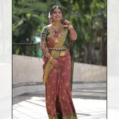 A full-length portrait of the bride. Her elegance and grace are on full display, with her makeup and hair perfectly styled to complement her traditional attire.