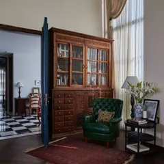 We transformed a corner of the founder's cabin into this cozy reading nook. The 10-foot-high bookcase is a refurbished antique medicine cabinet from Jodhpur, which we had to crane up seven storeys to install. It now holds books, awards, and curios collected over the years.