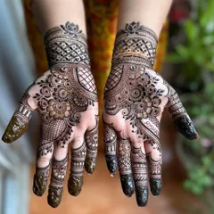 Happy Karwa Chauth. This is a popular style for the festival, with full palm coverage and detailed work on the fingers. I even hid the client's name, Risha, in the design.