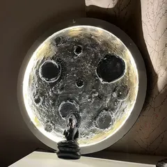 Bring the night sky into your home. Here’s a finished 3D moon lamp, created by a participant in our workshop, glowing beautifully with a small Buddha statue for a touch of serenity.
