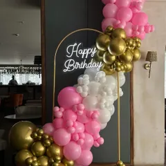 A closer look at our mini balloon backdrop, perfect for parties in space-constrained venues. The combination of pink, white, and gold chrome balloons is both fun and elegant.