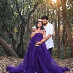 Celebrate your journey to motherhood with a romantic forest photoshoot. This deep purple maternity gown features a comfortable, bump-flattering design, and the rich color looks stunning against the natural greenery and golden hour light.
