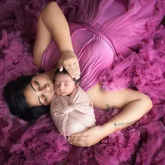 There is nothing more precious than the bond between a mother and her newborn. This overhead shot, surrounded by soft tulle, creates a dreamy, angelic portrait of your new baby.