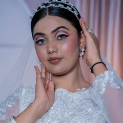 A close-up of the Christian bridal makeup. The pearl headband and earrings add a touch of elegance, and the makeup is kept fresh and luminous to match.