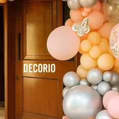 A balloon garland is a great way to frame a doorway and make the entrance to your home feel special for a welcome baby party. This one uses a soft palette of peach, orange, and silver with small butterfly details.