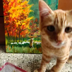 My ginger cat posing with my award-winning painting. He's my little muse and is always around when I'm creating.