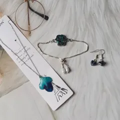 This is the complete jewelry set I made from a client's blue orchid. The set includes a stunning pendant, a flower-shaped charm bracelet, and delicate heart-shaped earrings.