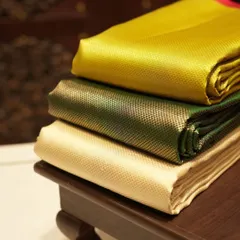 We stock a wide range of silks for every taste. This stack shows the beautiful sheen of our plain silk collection in vibrant yellow, green, and cream.