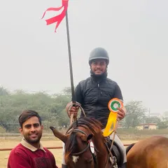 A rider and his horse posing with their winnings from the Junior National Equestrian Championship 2024. He secured gold medals in individual all over, lemon and peg, and ring and peg events.