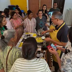 A group gathers around the cooking station, eager to learn the secrets of ashram cuisine. Our workshops are interactive, informative, and full of community spirit.
