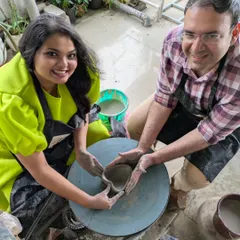 The smiles say it all. This couple is having a great time working together on the pottery wheel, shaping a heart-themed bowl. I love seeing partners collaborate and create their first piece.