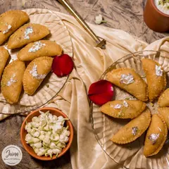 A festive platter of our authentic Gujiyas, garnished with silver leaf. These are perfect for serving guests or gifting to friends and family during Holi.