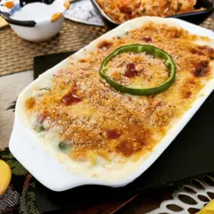 A classic Vegetable Au Gratin, featuring assorted vegetables in a creamy white sauce, topped with breadcrumbs and cheese, then baked until golden and bubbly.