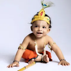 The joy on their faces says it all. This close-up from a 'Little Krishna' baby shoot captures the pure, happy expression that makes these themed sessions so special.