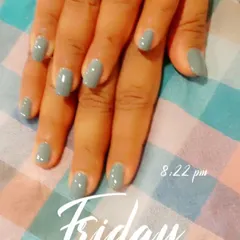 A solid coat of muted grey-green polish on short, natural nails. This is a great example of a chic, modern neutral color that goes with everything.